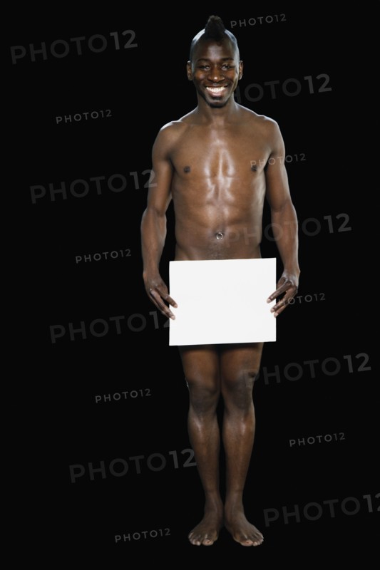 Nude African man with blank paper in front of genital area