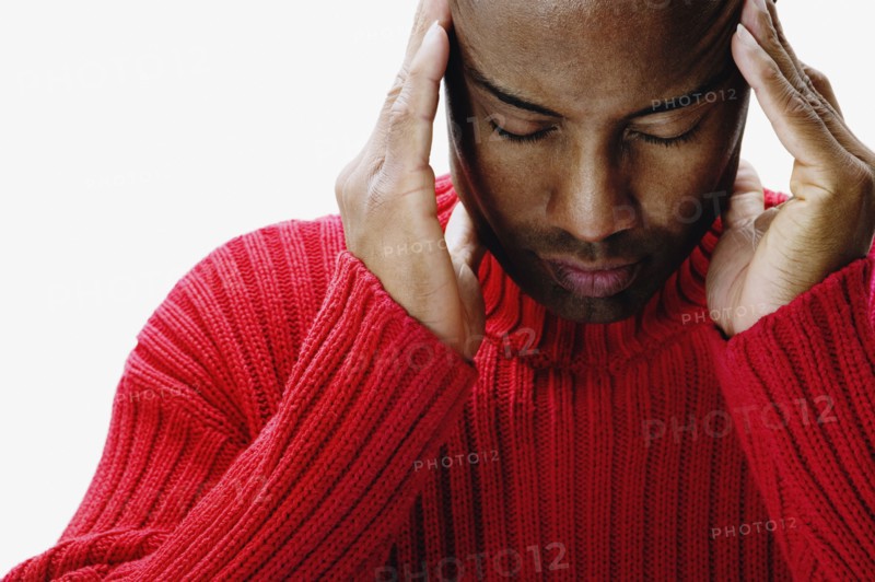 African man rubbing his temples