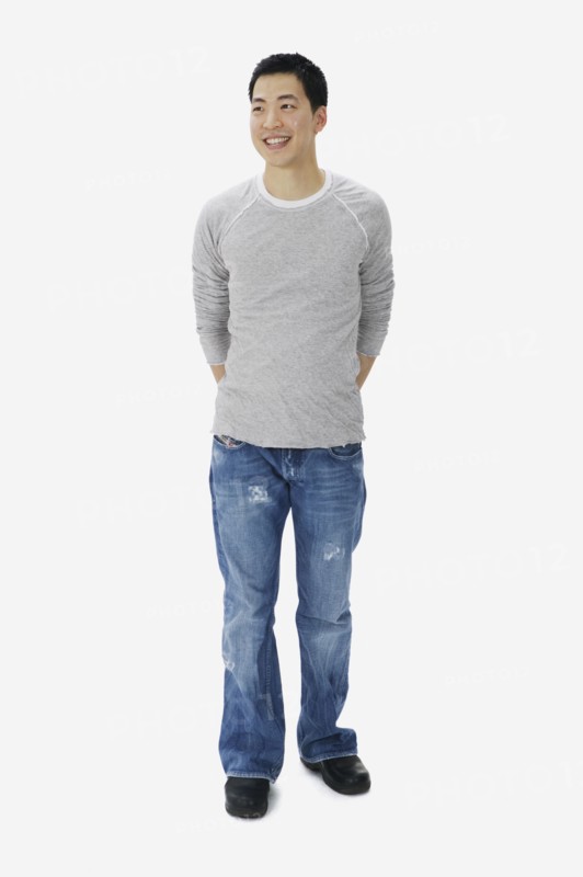 Portrait of Asian man with hands behind back
