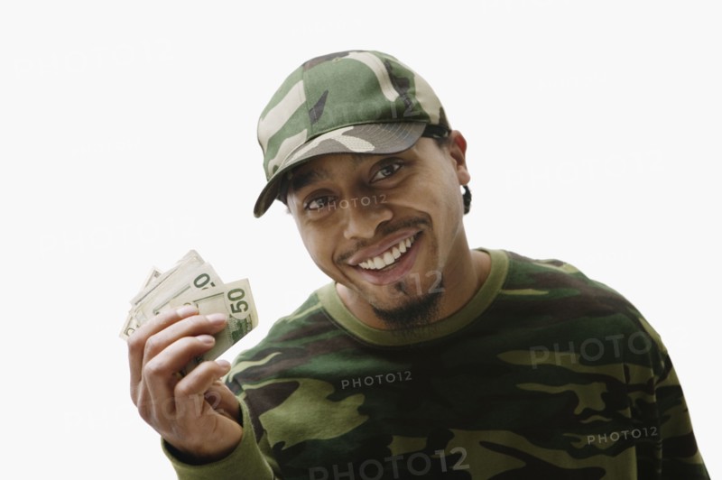 Portrait of African man holding handful of money
