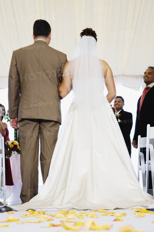 Bride being walked down aisle