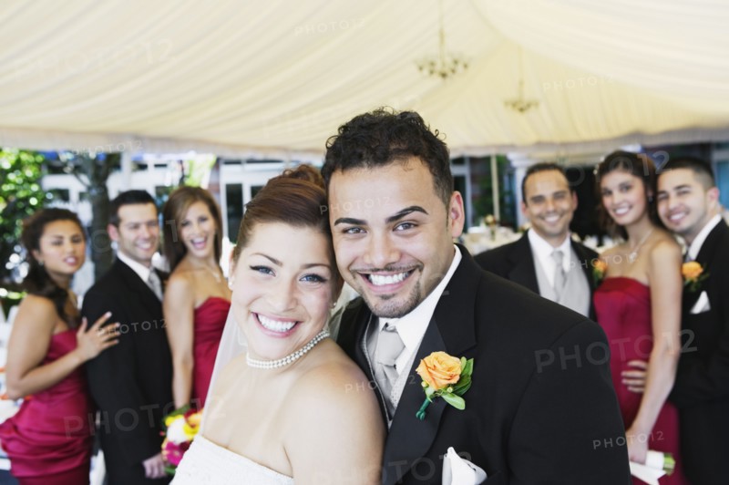 Multi-ethnic bride and groom hugging