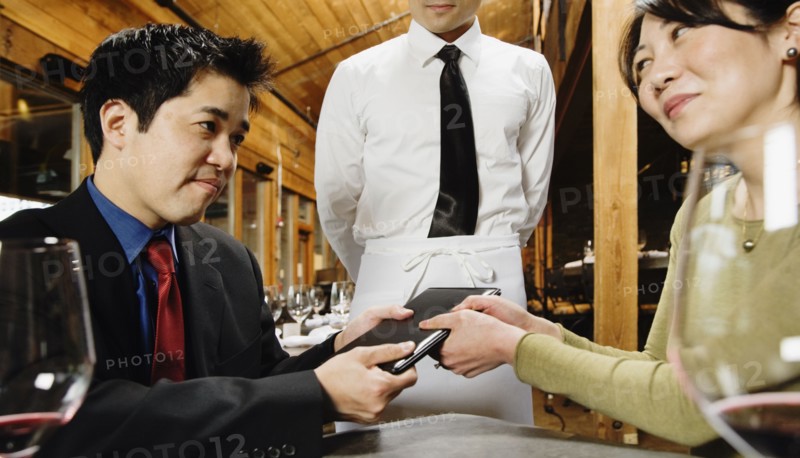 Asian couple fighting over restaurant bill