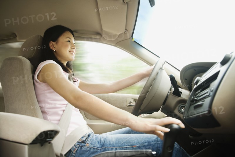 Asian teenager driving car