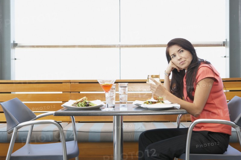 Asian woman waiting at restaurant table