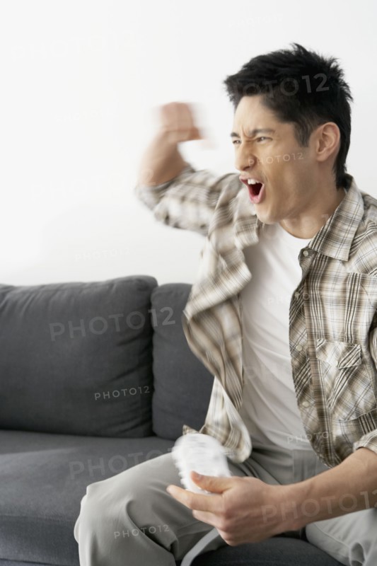 Asian man playing video games