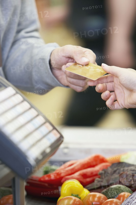 Man paying with credit card at grocery store