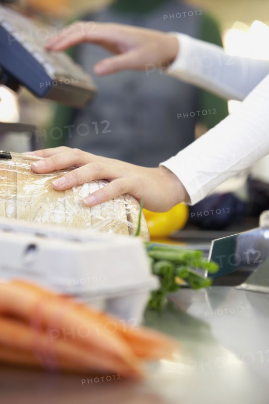 Cashier ringing up groceries