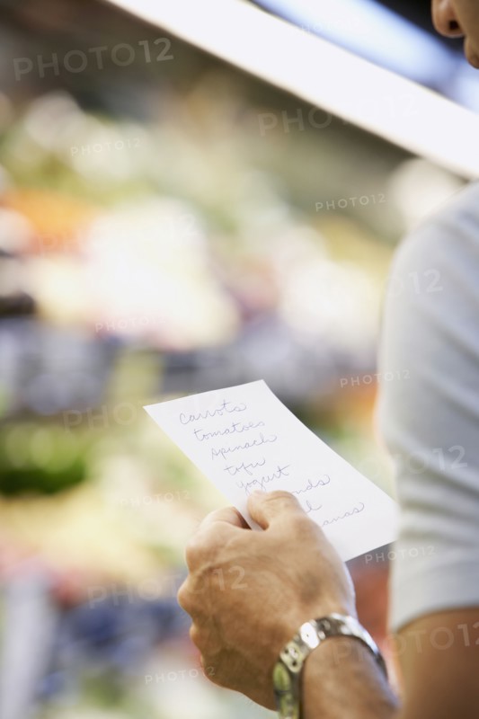 Hispanic man reading grocery list
