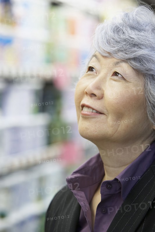 Senior Asian woman looking up