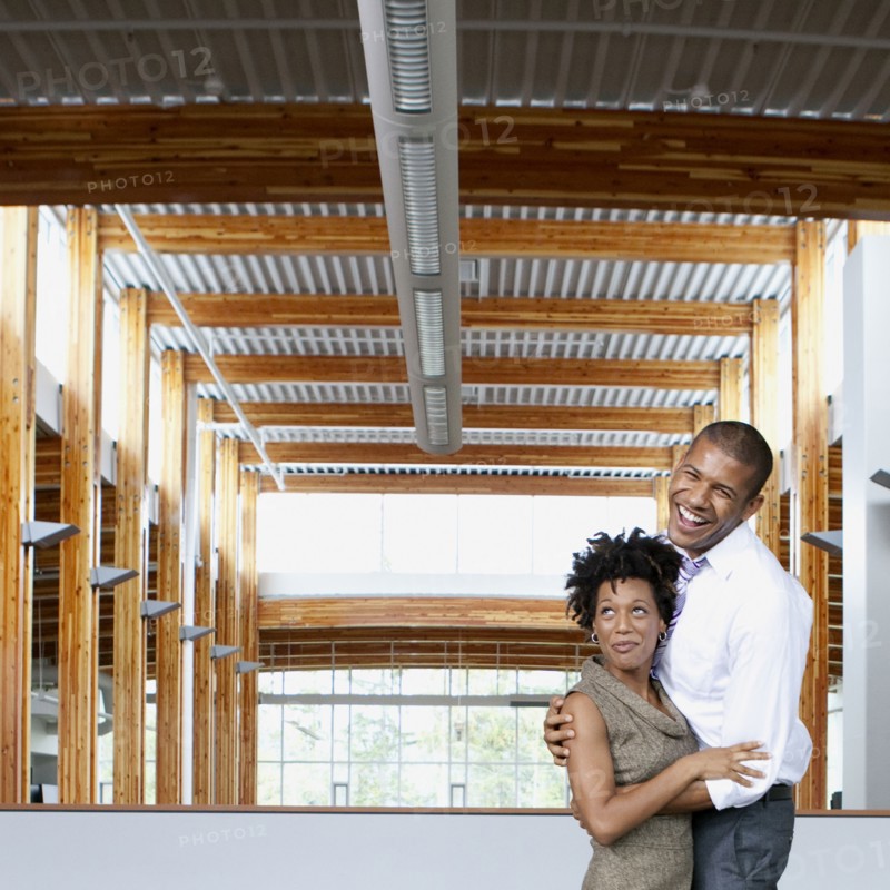 Couple laughing in empty office space