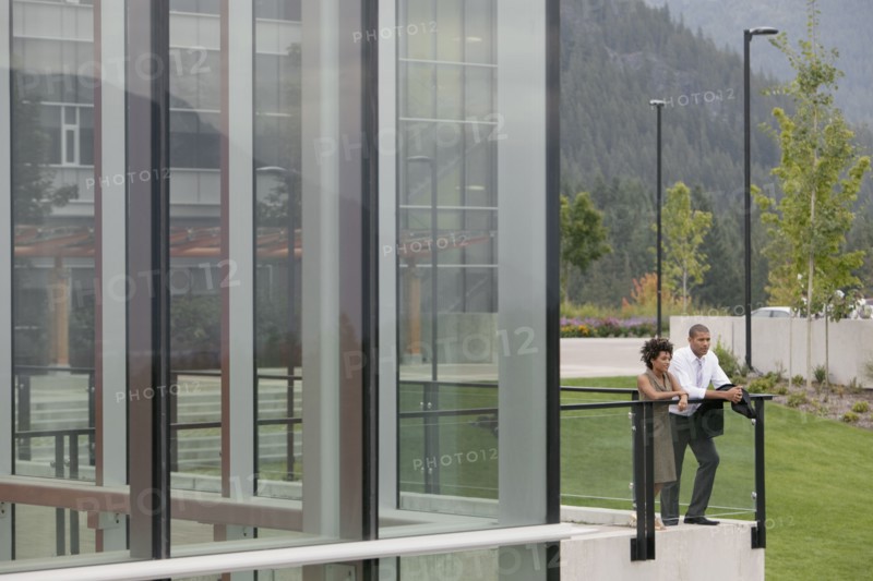 Business people standing on balcony