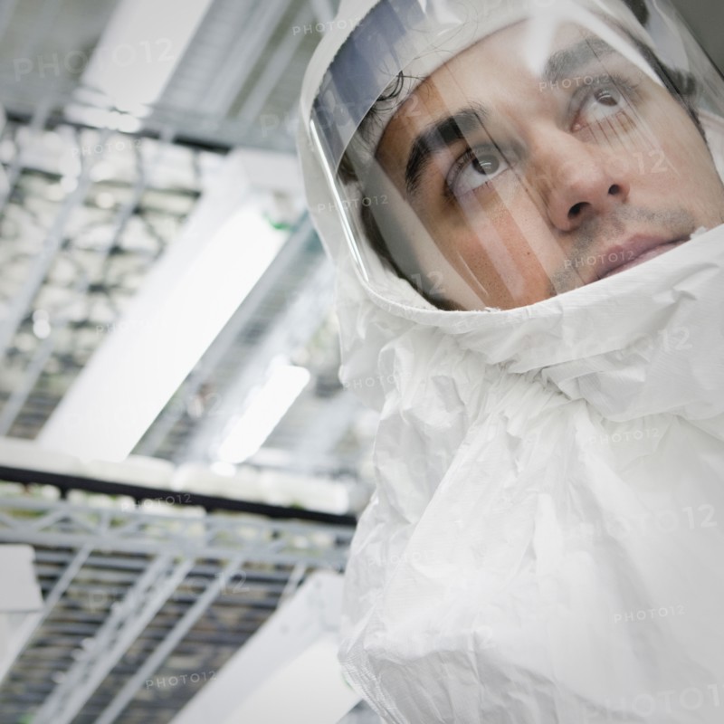 Middle Eastern scientist in clean suit in laboratory