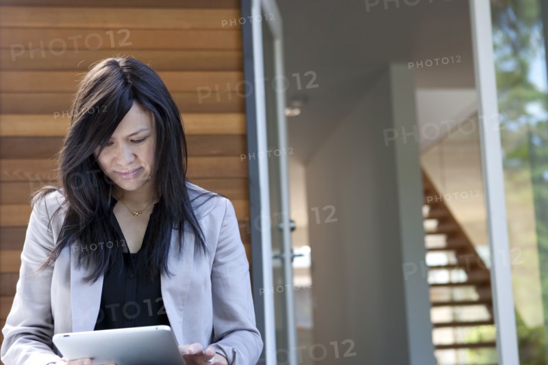 Mixed race real estate agent using digital tablet