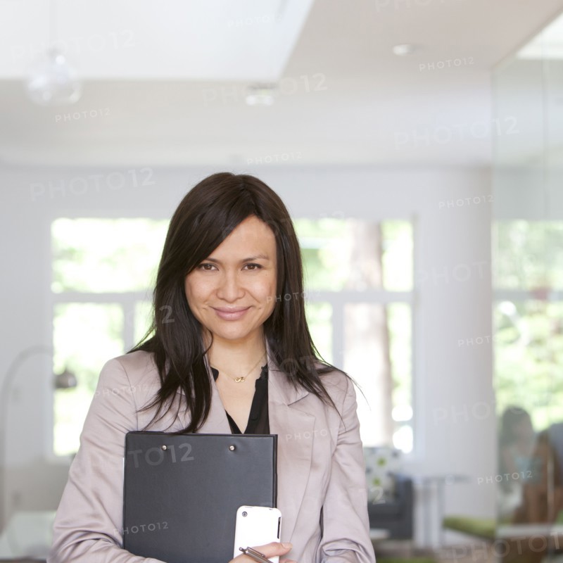 Smiling real estate agent standing in home