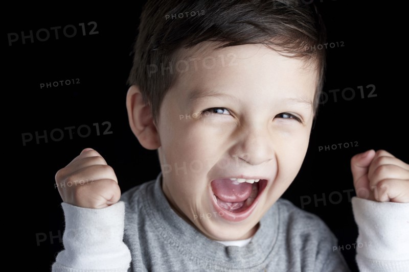 Close up of Hispanic boy cheering