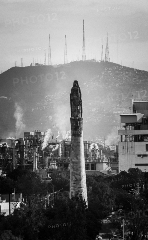 Statue on pillar in cityscape