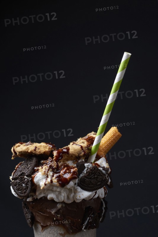 Straw in ice cream sundae with cookies