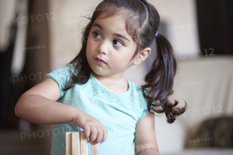 Curious Hispanic girl looking away