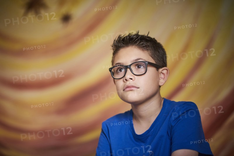Curious Hispanic boy looking away