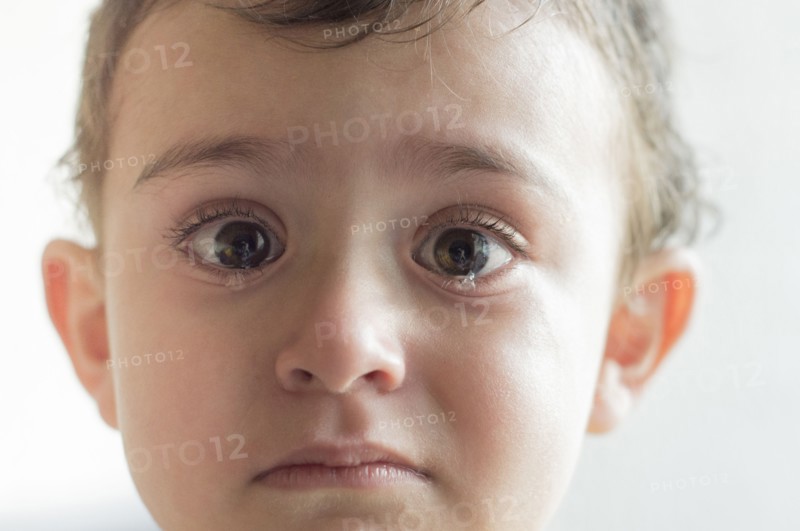Face of Hispanic boy crying