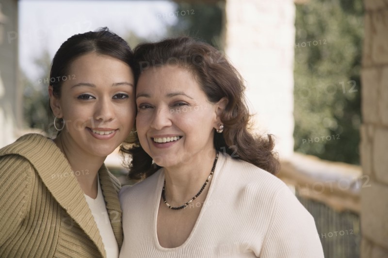 Multi-ethnic mother and daughter smiling