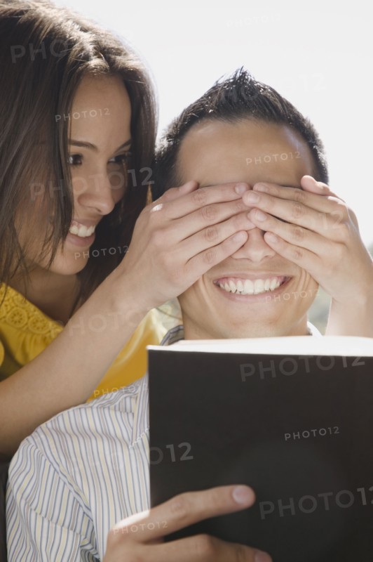 Girlfriend covering boyfriend's eyes
