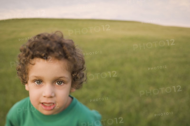Mixed race boy in field