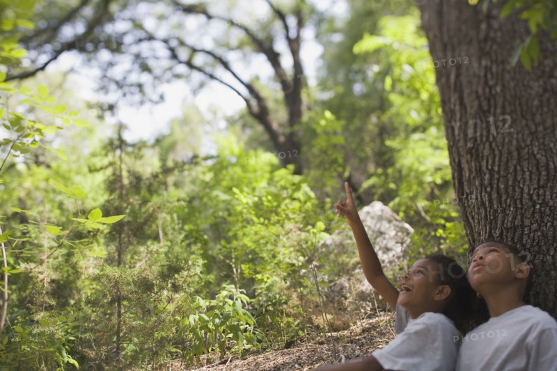 African boy and girl sitting under tree