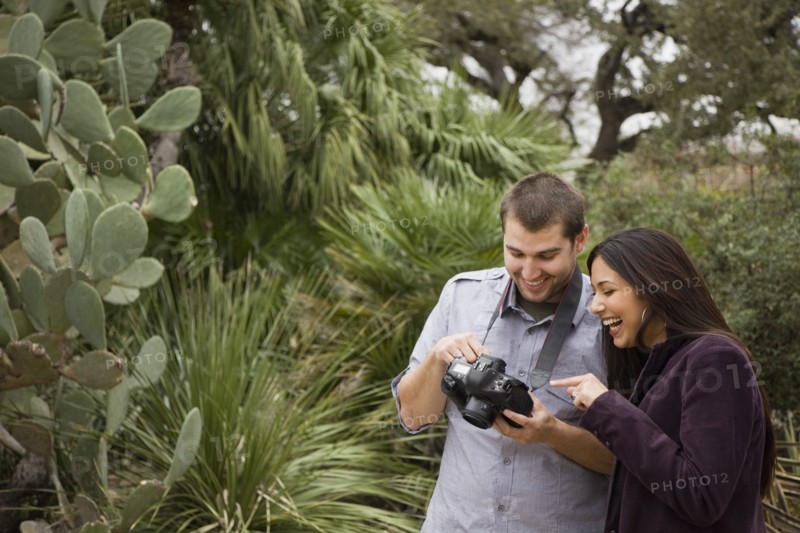 Couple looking at pictures on digital camera