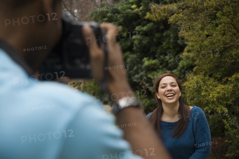 Man taking picture of smiling girlfriend