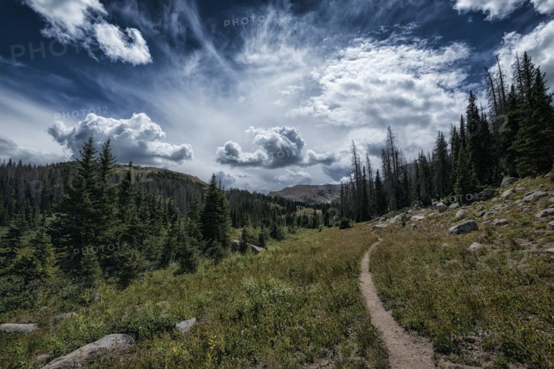 Clouds over trail in rocky landscape