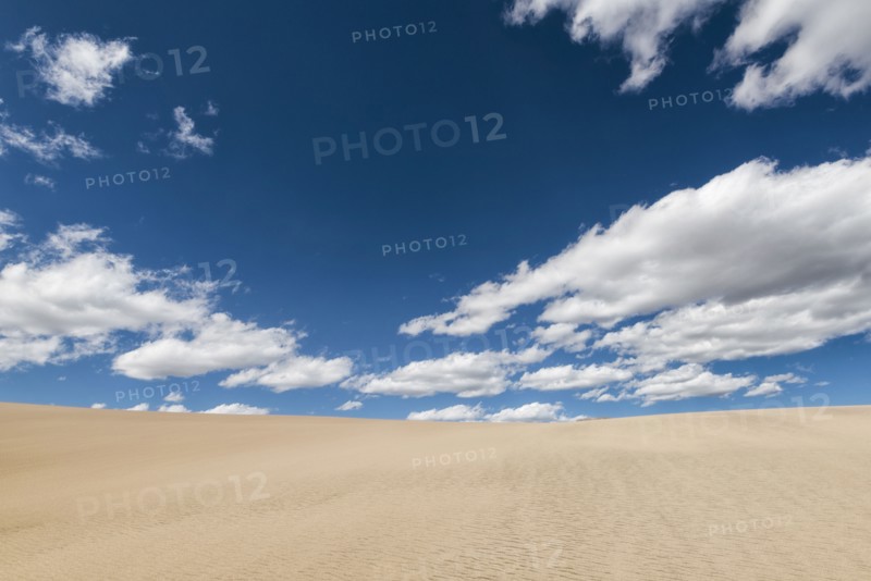 Clouds over barren desert landscape