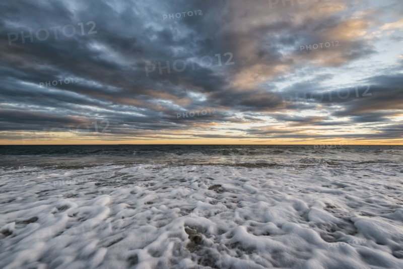 Foam in waves on ocean beach