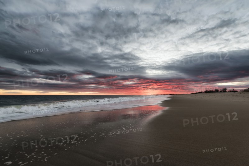 Ocean waves on beach at sunset