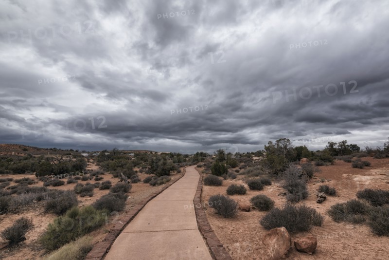 Path under clouds in Arches National Park