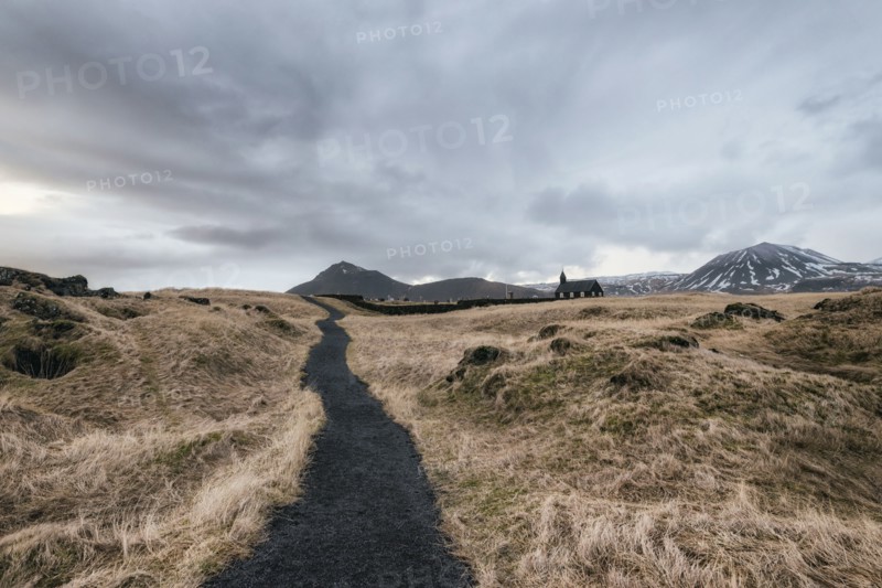 Dirt road to distant church