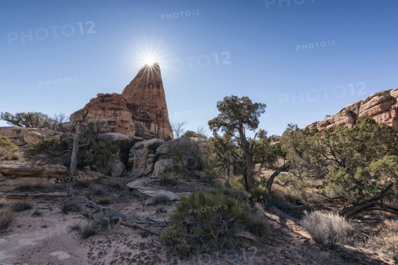 Sun in blue sky over desert
