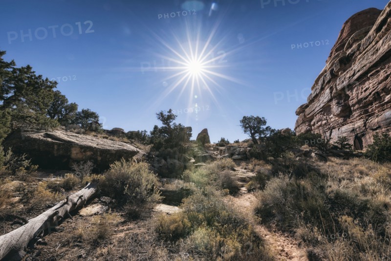 Sun in blue sky over desert