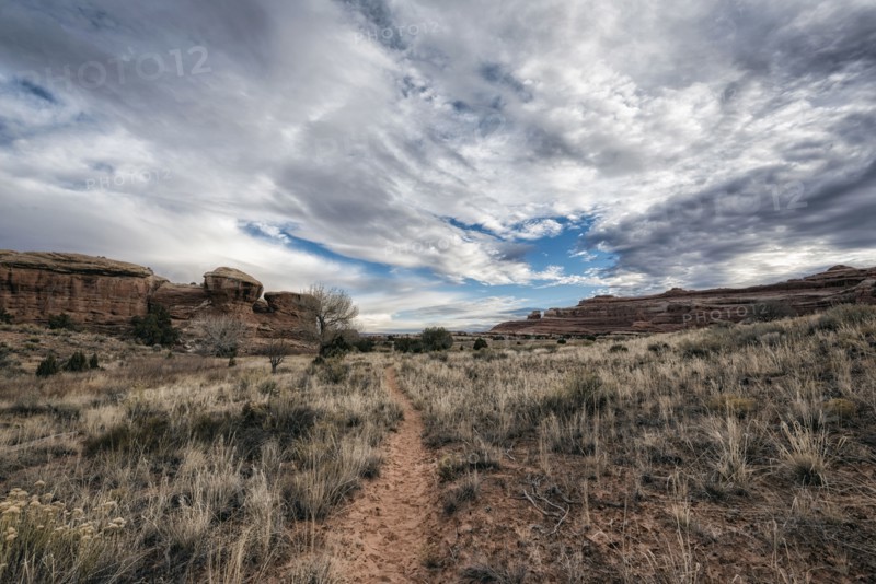 Clouds over desert path
