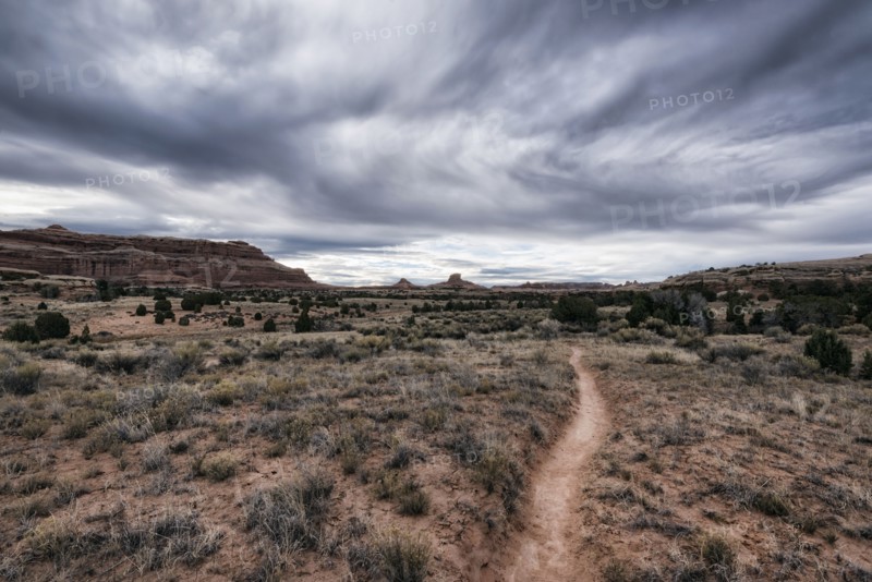 Clouds over desert path