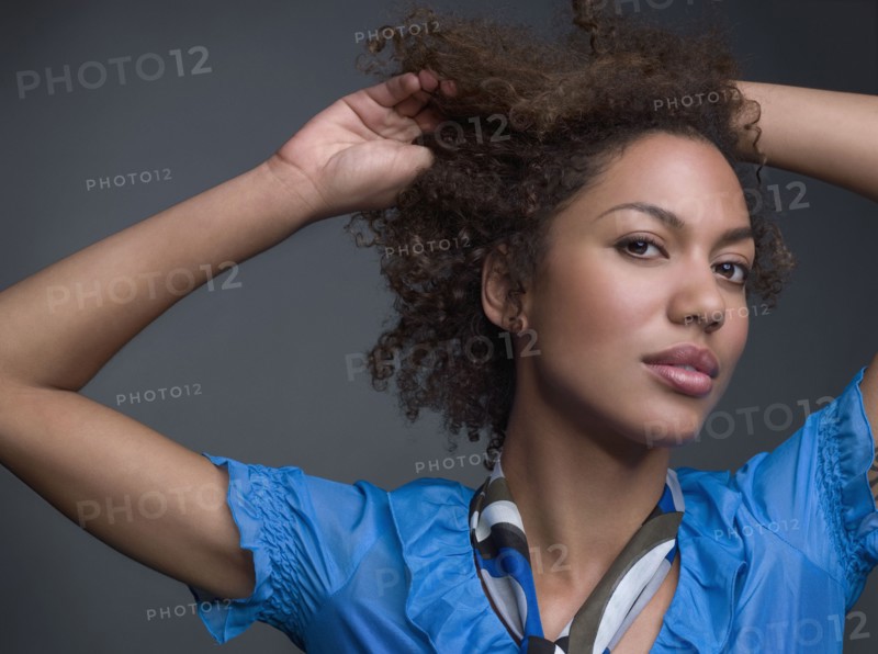 Mixed Race woman with hands in hair