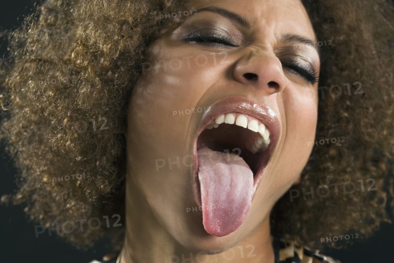 Mixed Race woman sticking out tongue
