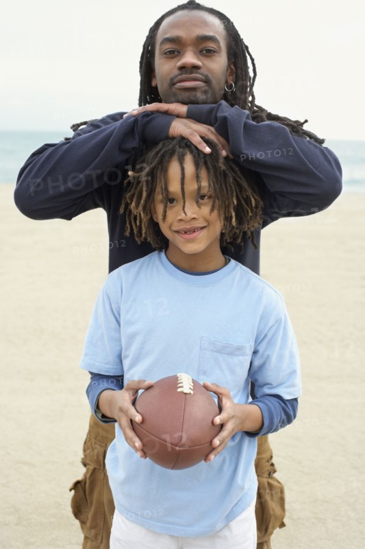 African father and son with football