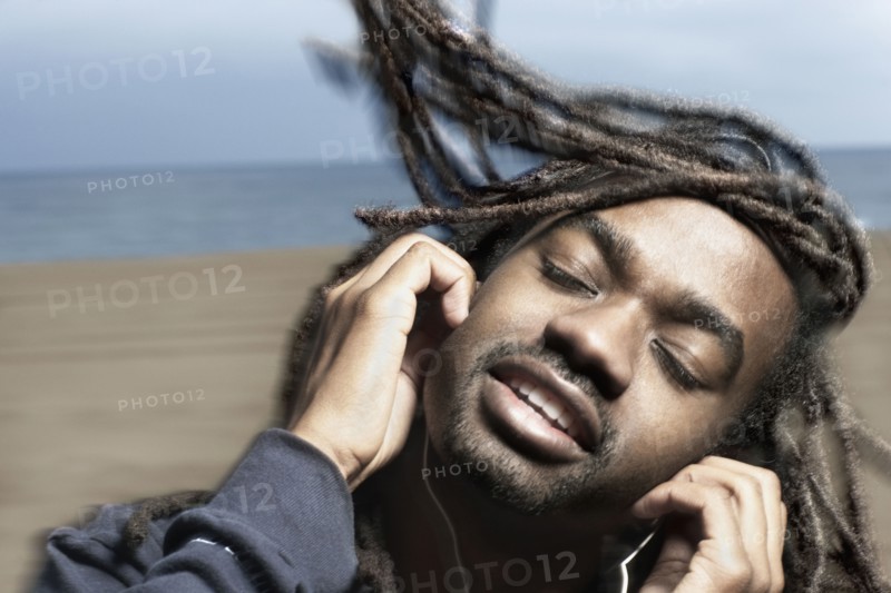 African man listening to headphones
