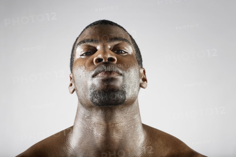 Serious African man sweating