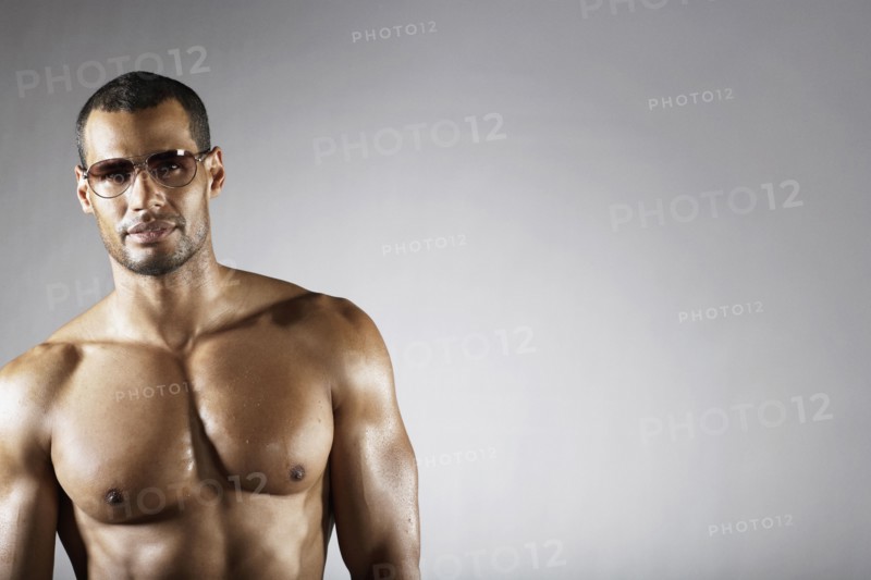 Bare chested mixed race man in sunglasses