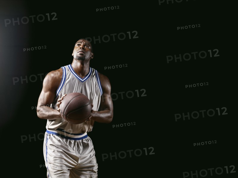 African basketball player holding basketball