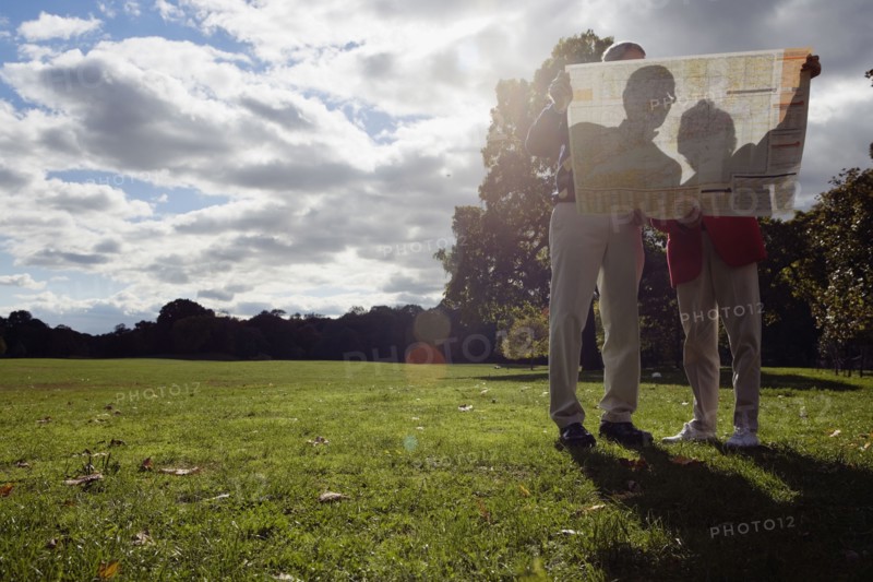 Couple looking at map outdoors