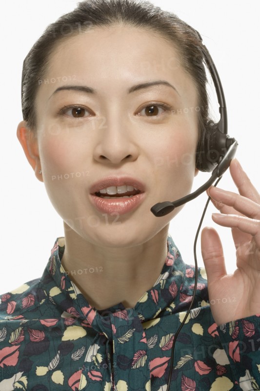 Studio shot of Asian woman wearing headset